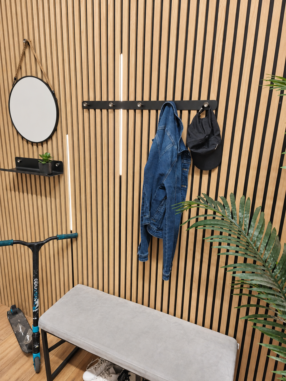 Black five-hook coat rack and matching Wood Vibe shelf on a wood slat wall.